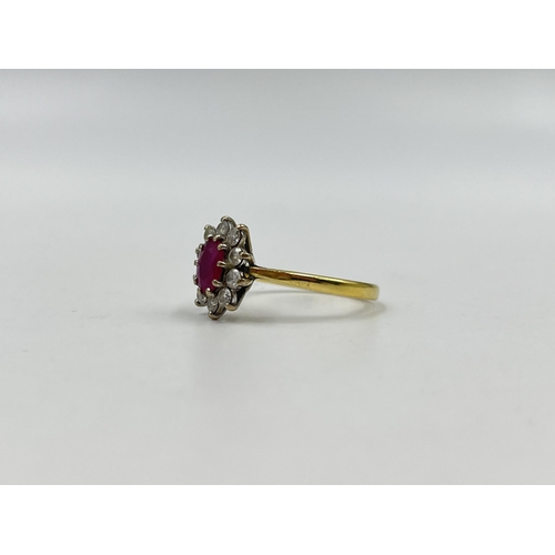 1258 - A hallmarked 18ct gold ruby and diamond halo ring, size U - approx. gross weight 3.82 grams