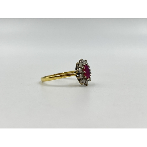 1258 - A hallmarked 18ct gold ruby and diamond halo ring, size U - approx. gross weight 3.82 grams