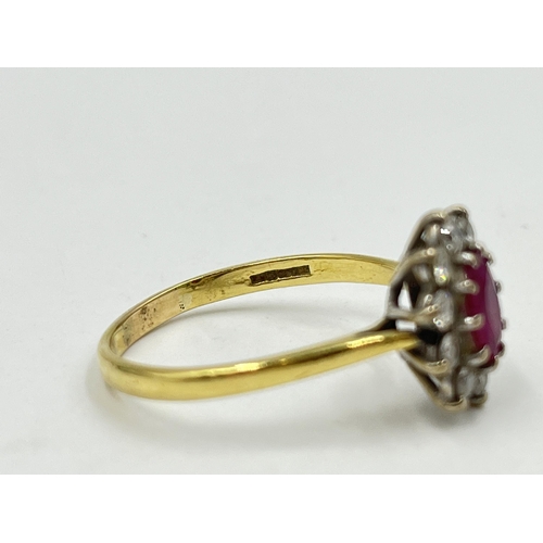 1258 - A hallmarked 18ct gold ruby and diamond halo ring, size U - approx. gross weight 3.82 grams