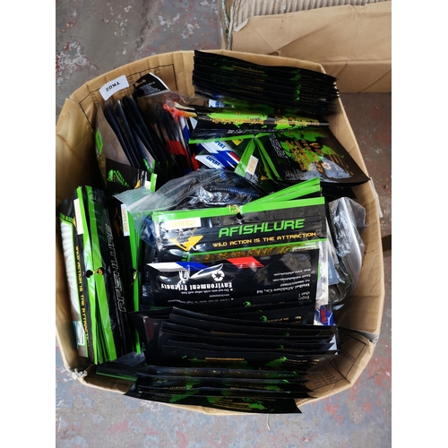 970 - A box containing a large collection of fishing lures to include rattling crank bait and soft plastic