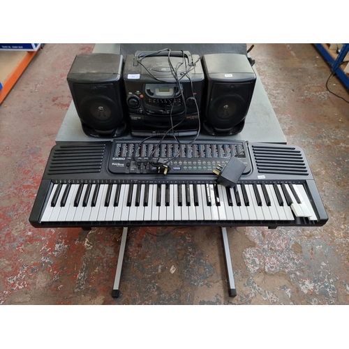 816 - Two items, one Casio CT-636 electronic keyboard with stand and power adaptor and one Philips AZ2100/... 