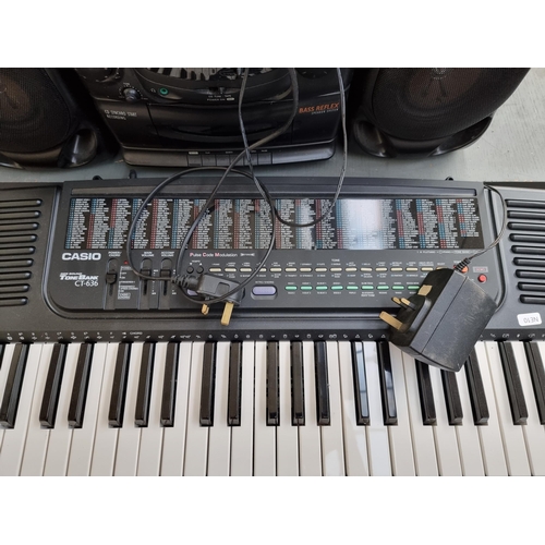 816 - Two items, one Casio CT-636 electronic keyboard with stand and power adaptor and one Philips AZ2100/... 