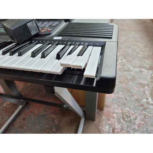 816 - Two items, one Casio CT-636 electronic keyboard with stand and power adaptor and one Philips AZ2100/... 