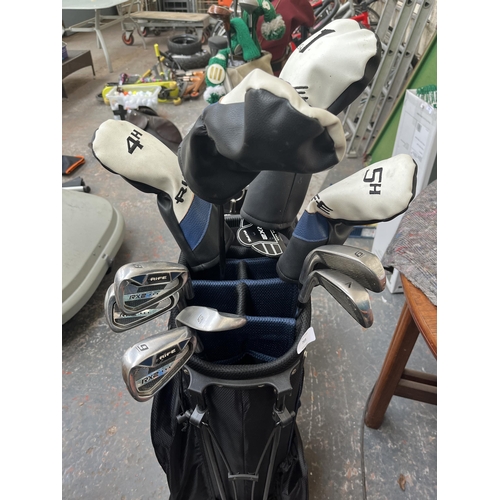 703 - Two golf bags containing Rife RX2 clubs