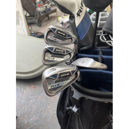 703 - Two golf bags containing Rife RX2 clubs