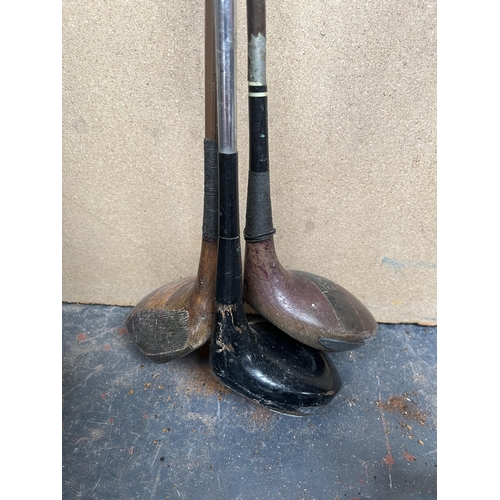 706 - A collection of antique and later golf clubs