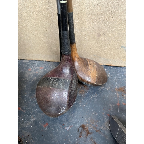 706 - A collection of antique and later golf clubs