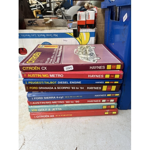 758 - A large collection of boxed car parts and car workshop manuals to include oil filters, timing belts,... 