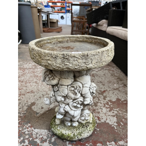 770 - A cast stone bird bath with Snow White and the Seven Dwarfs design