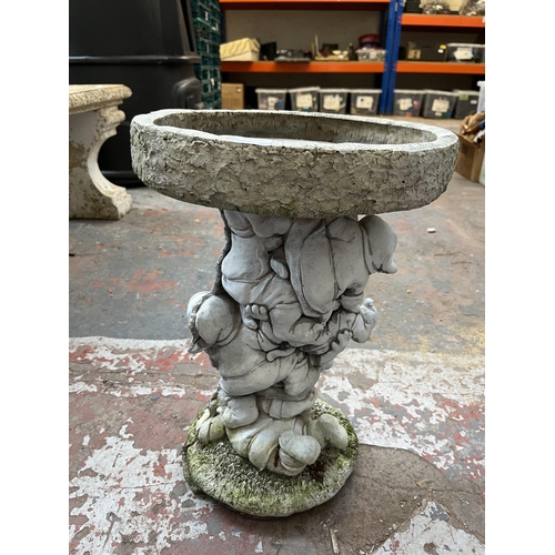 770 - A cast stone bird bath with Snow White and the Seven Dwarfs design