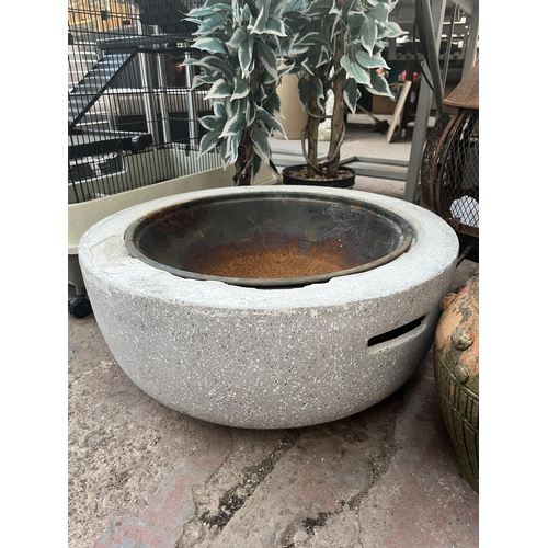 787 - A collection of garden items to include fibreglass firepit, metal chiminea, planters etc.