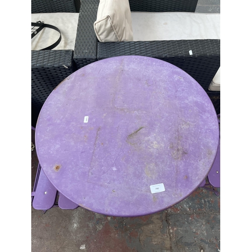 790 - A three piece purple metal bistro set comprising two folding chairs and table