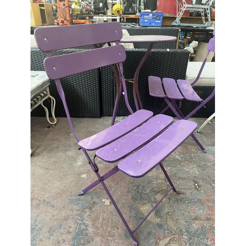 790 - A three piece purple metal bistro set comprising two folding chairs and table