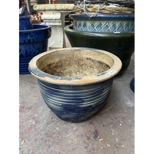 792 - Eight garden items, one glazed birdbath, five planters and two hanging baskets