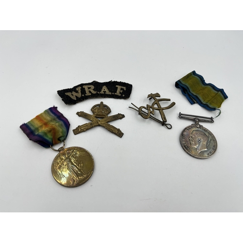 1402 - Five military items, two WWI medals presented to 117968 Pte. L. J. Warren M. G. C, two cap badges an... 