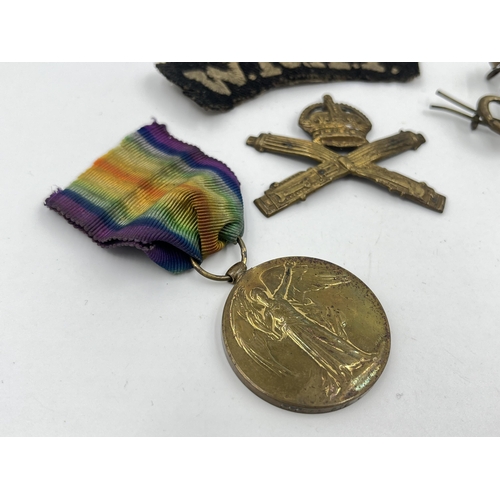 1402 - Five military items, two WWI medals presented to 117968 Pte. L. J. Warren M. G. C, two cap badges an... 