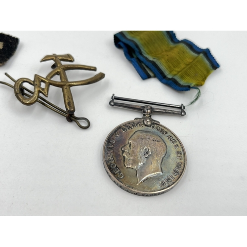 1402 - Five military items, two WWI medals presented to 117968 Pte. L. J. Warren M. G. C, two cap badges an... 