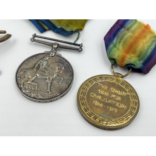 1402 - Five military items, two WWI medals presented to 117968 Pte. L. J. Warren M. G. C, two cap badges an... 