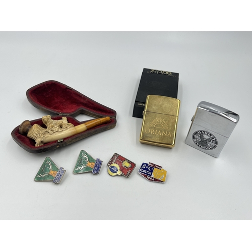 1408 - Seven items, four 1960s Butlin's enamel badges, two Zippo cigarette lighters and one leather cased c... 