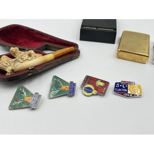 1408 - Seven items, four 1960s Butlin's enamel badges, two Zippo cigarette lighters and one leather cased c... 