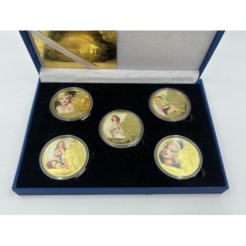 1440 - A cased set of five Marilyn Monroe 24k gold plated commemorative coins with certificate of authentic... 