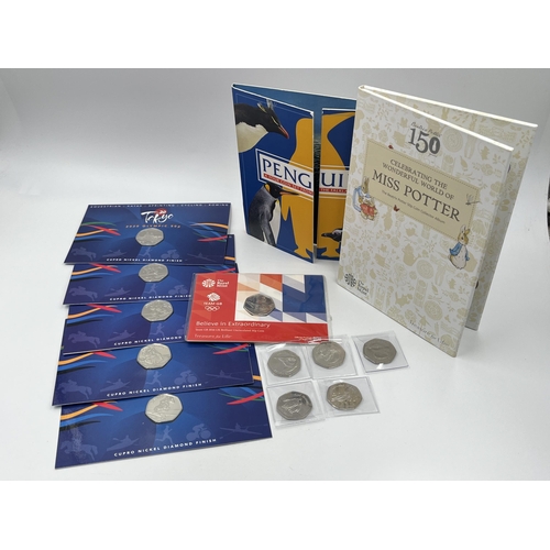 1441 - A collection of British Commemorative Pobjoy Mint coins to include Falkland islands penguin 50p coin... 