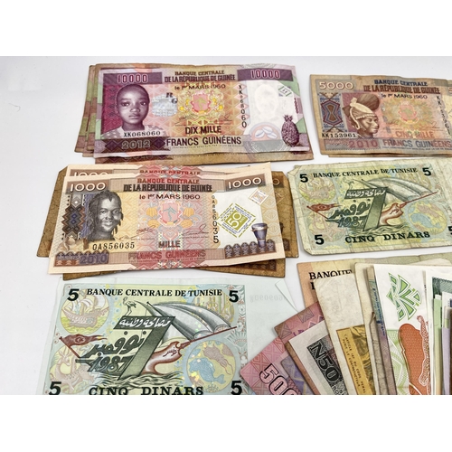 1446 - A collection of African banknotes to include examples from Guinea, Tunisia, Rwanda, Kenya, Bank of C... 