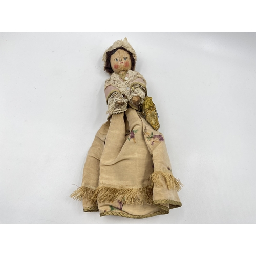 1475 - An antique Queen Anne type hand painted and carved wooden doll with hand decorated silk clothing - a... 