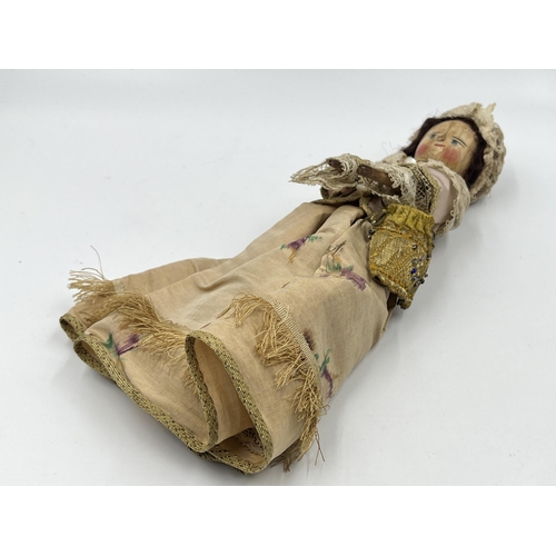 1475 - An antique Queen Anne type hand painted and carved wooden doll with hand decorated silk clothing - a... 