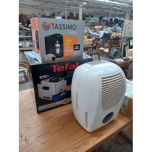 925 - Four items, one boxed Bosch Tassimo coffee machine, one boxed Tefal deep fat fryer, one Argos dehumi... 