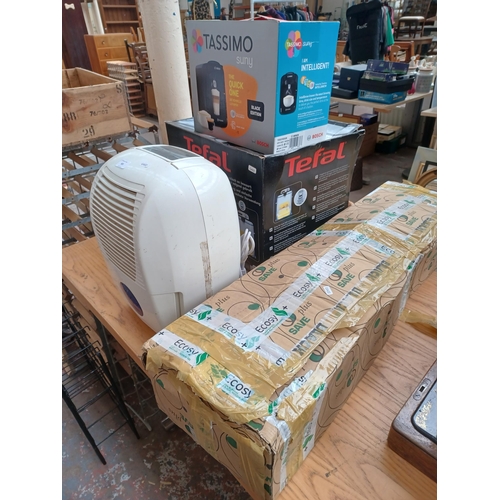 925 - Four items, one boxed Bosch Tassimo coffee machine, one boxed Tefal deep fat fryer, one Argos dehumi... 