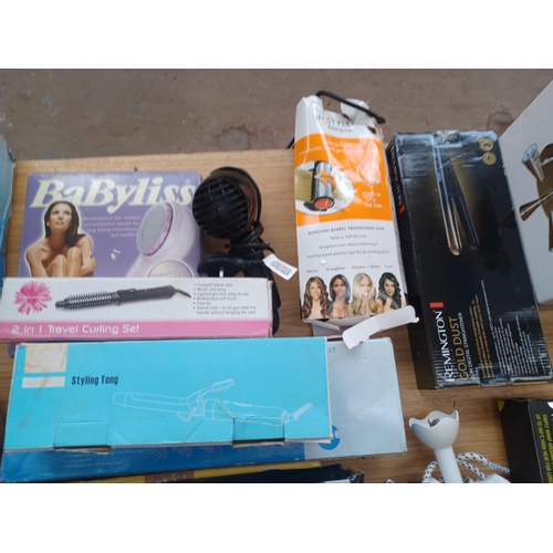 932 - Fifteen items to include steam iron, hand blender, boxed halogen spot light, wax heater, body massag... 