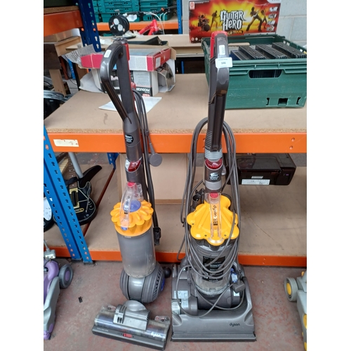 946 - Two Dyson upright bagless vacuum cleaners, one DC33 and one DC40