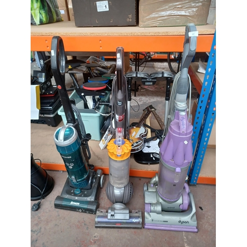 947 - Three upright bagless vacuum cleaners, one Dyson DC07, one Dyson DC40 and one Hoover