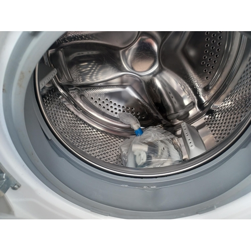 954 - A Logik L712WM20 7kg 1200rpm spin 60cm washing machine with instruction manual, pipe and fixings