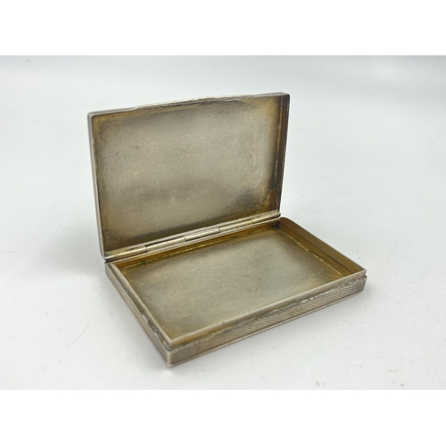 1335 - A stamped .835 silver engine turned cigarette case with rolled gold detail - approx. gross weight 51... 