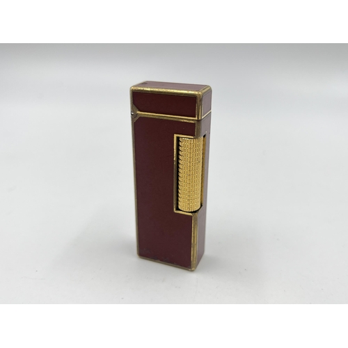 1417 - A Dunhill Rollagas gold plate and burgundy lacquer cigarette lighter