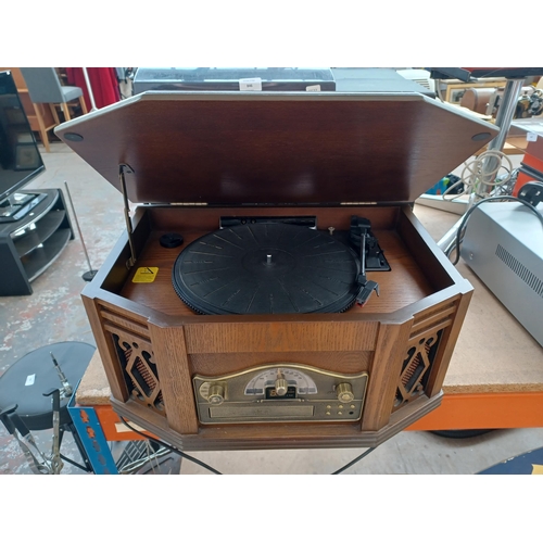 846A - A Steepletone 2057 retro style stereo system comprising three speed turntable, two-band radio, casse... 