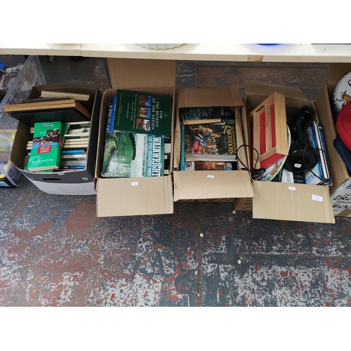 982C - Four boxes containing a large quantity of books, Ring Lighting black plastic desk lamp etc.