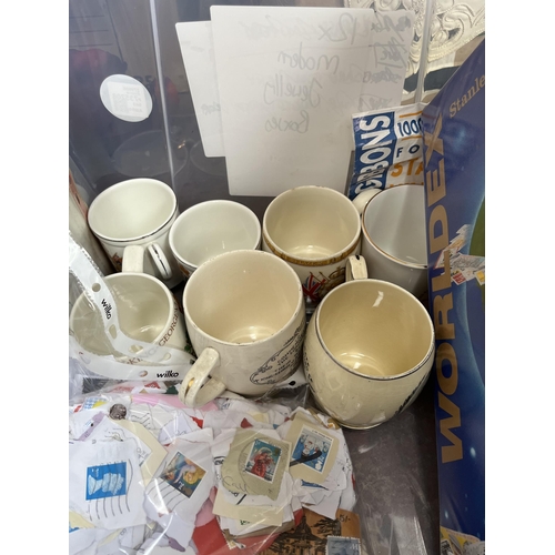 976B - A box containing commemorative mugs, Stanley Gibbons stamp album with contents, Eagle Number 3 annua... 