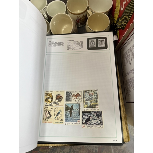 976B - A box containing commemorative mugs, Stanley Gibbons stamp album with contents, Eagle Number 3 annua... 