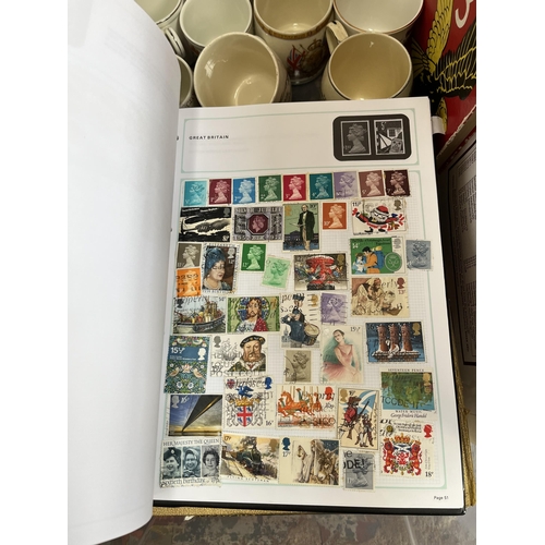 976B - A box containing commemorative mugs, Stanley Gibbons stamp album with contents, Eagle Number 3 annua... 