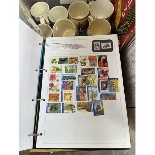 976B - A box containing commemorative mugs, Stanley Gibbons stamp album with contents, Eagle Number 3 annua... 