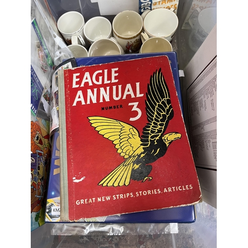 976B - A box containing commemorative mugs, Stanley Gibbons stamp album with contents, Eagle Number 3 annua... 