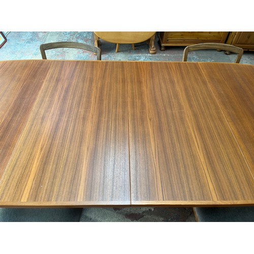 19 - A mid 20th century teak extending dining table and four G Plan teak dining chairs - approx. 250cm wh... 