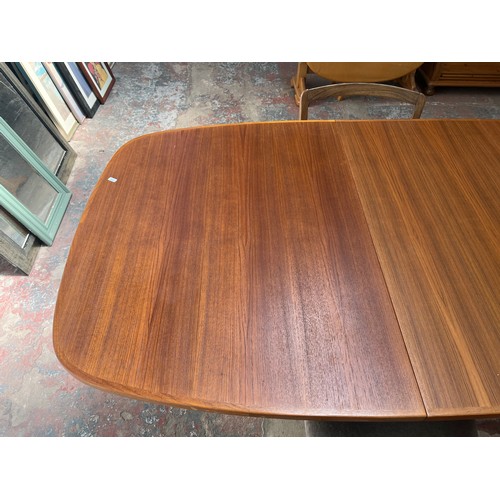 19 - A mid 20th century teak extending dining table and four G Plan teak dining chairs - approx. 250cm wh... 