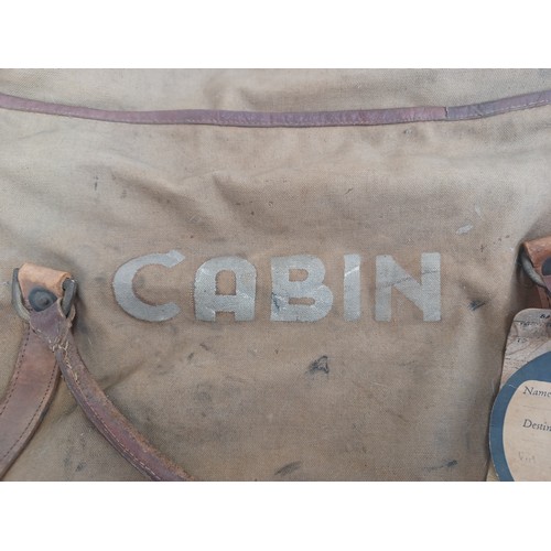 702C - A mid 20th century canvas and leather military bag marked K.R. RANS N.STAFFS REG'T M.E.L.F. FAYID EG... 