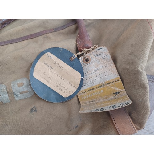 702C - A mid 20th century canvas and leather military bag marked K.R. RANS N.STAFFS REG'T M.E.L.F. FAYID EG... 