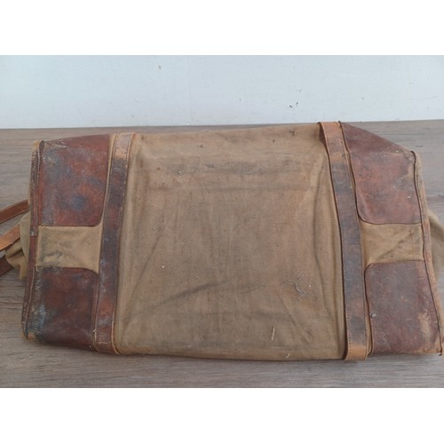 702C - A mid 20th century canvas and leather military bag marked K.R. RANS N.STAFFS REG'T M.E.L.F. FAYID EG... 