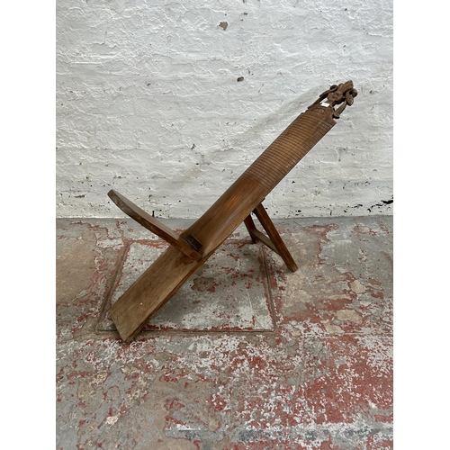 26A - A carved teak folding plank chair - approx. 144cm when folded